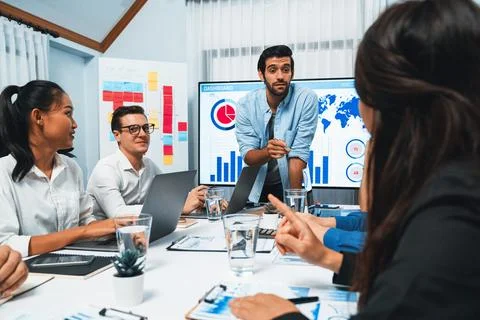 Analyst team utilizing BI Fintech to analyze financial data at table. Prudent Stock Photos