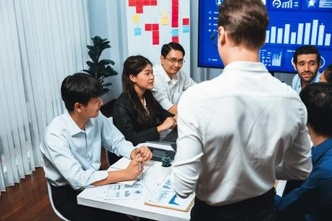 Analyst team utilizing BI Fintech to analyze financial data at table. Prudent Stock Photos