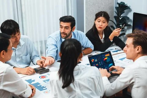 Analyst team utilizing BI Fintech to analyze financial data at table. Prudent Stock Photos