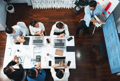 Analyst team utilizing BI Fintech to analyze financial data at table. Prudent Stock Photos