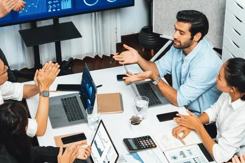 Analyst team utilizing BI Fintech to analyze financial data at table. Prudent Stock Photos