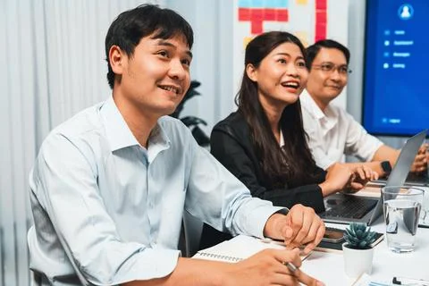 Analyst team utilizing BI Fintech to analyze financial data at table. Prudent Stock Photos