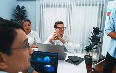 Analyst team utilizing BI Fintech to analyze financial data at table. Prudent Stock Photos