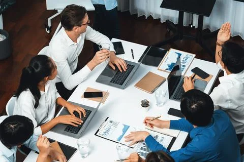 Analyst team utilizing BI Fintech to analyze financial data at table. Prudent Stock Photos
