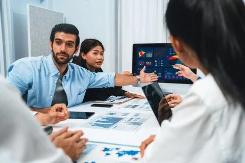 Analyst team utilizing BI Fintech to analyze financial data at table. Prudent Stock Photos