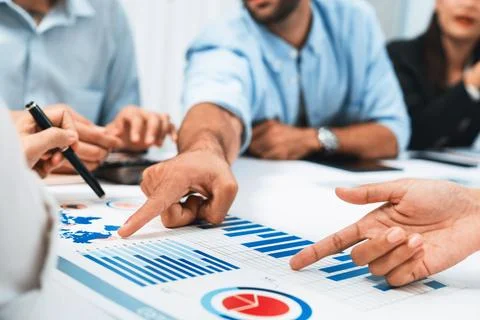 Analyst team utilizing BI Fintech to analyze financial data at table. Prudent Stock Photos
