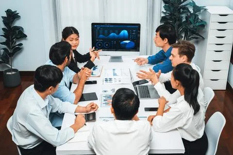 Analyst team utilizing BI Fintech to analyze financial data at table. Prudent Stock Photos