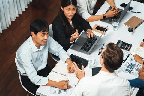Analyst team utilizing BI Fintech to analyze financial data at table. Prudent Stock Photos