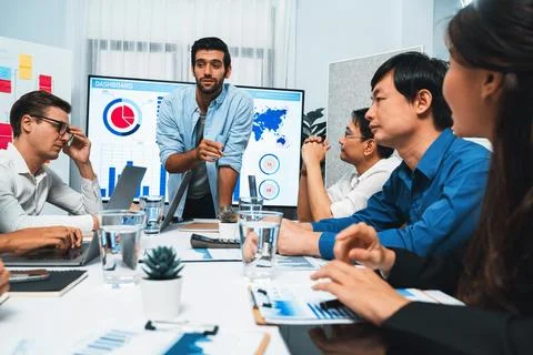 Analyst team utilizing BI Fintech to analyze financial data at table. Prudent Stock Photos