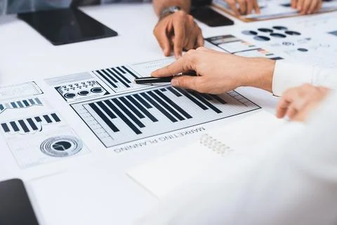 Analyst team utilizing BI Fintech to analyze financial data at table. Prudent Stock Photos