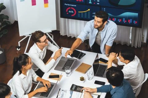 Analyst team utilizing BI Fintech to analyze financial data at table. Prudent Stock Photos