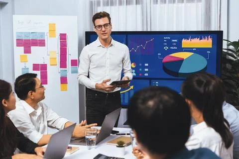 Analyst team utilizing BI Fintech to analyze financial data at table. Prudent Stock Photos