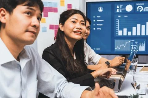 Analyst team utilizing BI Fintech to analyze financial data at table. Prudent Stock Photos
