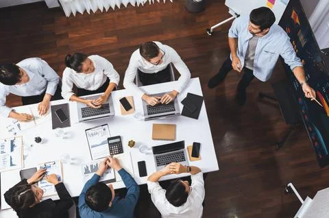 Analyst team utilizing BI Fintech to analyze financial data at table. Prudent Stock Photos