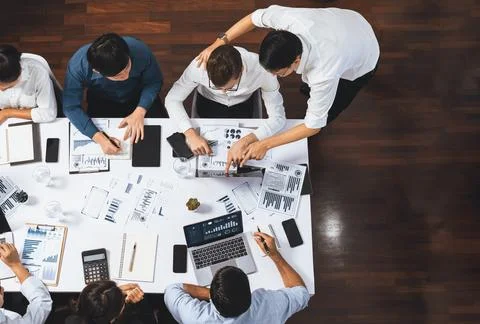 Analyst team utilizing BI Fintech to analyze financial data at table. Prudent Stock Photos