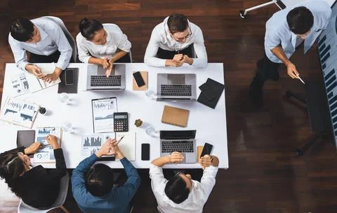 Analyst team utilizing BI Fintech to analyze financial data at table. Prudent Stock Photos