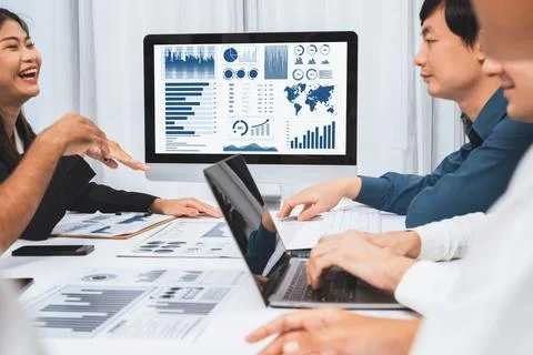 Analyst team utilizing BI Fintech to analyze financial data at table. Prudent Stock Photos