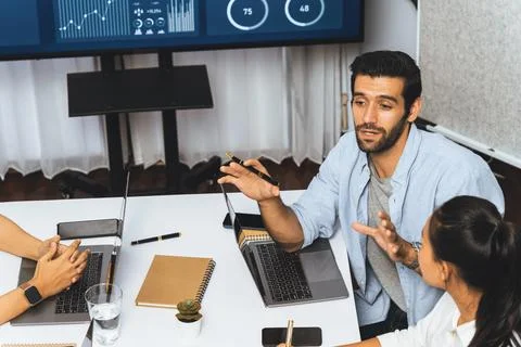 Analyst team utilizing BI Fintech to analyze financial data at table. Prudent Stock Photos