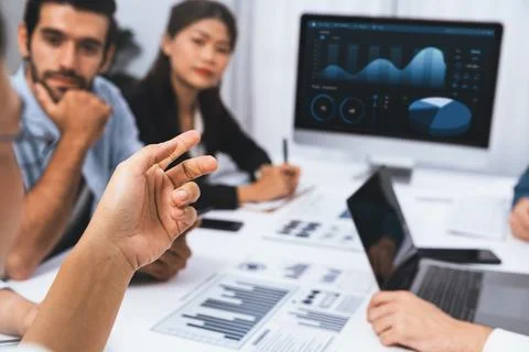 Analyst team utilizing BI Fintech to analyze financial data at table. Prudent Stock Photos