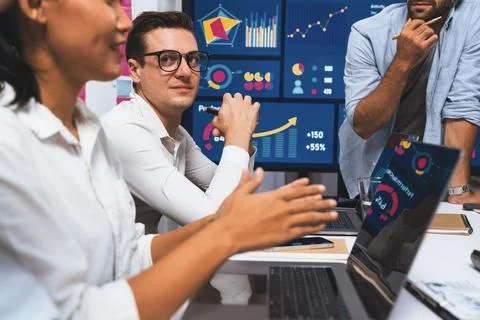 Analyst team utilizing BI Fintech to analyze financial data at table. Prudent Stock Photos