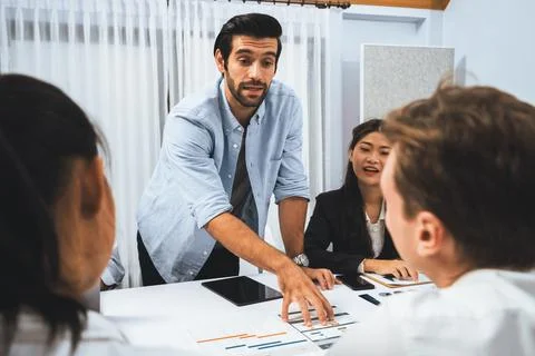 Analyst team utilizing BI Fintech to analyze financial data at table. Prudent Stock Photos