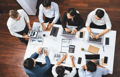 Analyst team utilizing BI Fintech to analyze financial data at table. Prudent Stock Photos