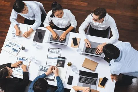 Analyst team utilizing BI Fintech to analyze financial data at table. Prudent Stock Photos