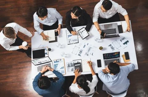 Analyst team utilizing BI Fintech to analyze financial data at table. Prudent Stock Photos
