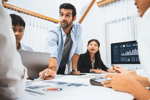 Analyst team utilizing BI Fintech to analyze financial data at table. Prudent Stock Photos