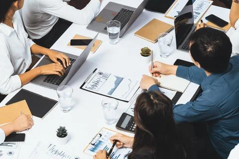 Analyst team utilizing BI Fintech to analyze financial data at table. Prudent Stock Photos
