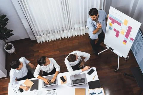 Analyst team utilizing BI Fintech to analyze financial data at table. Prudent Stock Photos