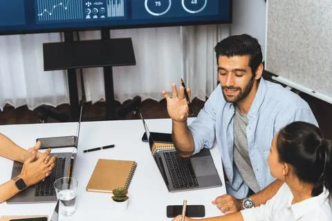 Analyst team utilizing BI Fintech to analyze financial data at table. Prudent Stock Photos