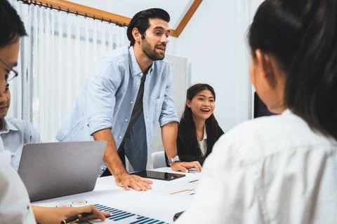 Analyst team utilizing BI Fintech to analyze financial data at table. Prudent Stock Photos