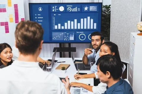 Analyst team utilizing BI Fintech to analyze financial data at table. Prudent Stock Photos