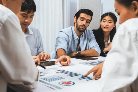 Analyst team utilizing BI Fintech to analyze financial data at table. Prudent Stock Photos