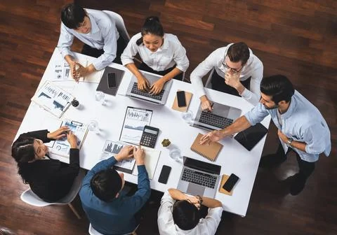 Analyst team utilizing BI Fintech to analyze financial data at table. Prudent Stock Photos