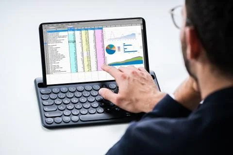Analyst Using Spreadsheet Report On Tablet Stock Photos