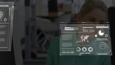 Analyst watching screen, data loading, panels sliding across face and graphs for Stock Footage 333019482