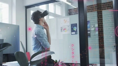 Analyst wearing VR headset scanning data charts while AR UI appearing around him Stock Footage 332844096