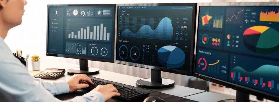 Analyst working on data analysis BI dashboard on computer monitor.Trailblazing Stock Photos