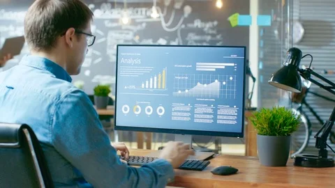Analyst Works on a Personal Computer Showing Statistics, Graphs and Charts.  Stock Footage 83170410