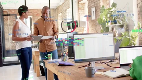 Analysts approaching desk, reading papers checking metrics as data overlay Stock Footage 332844173