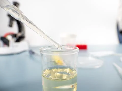 Analytical chemistry - a sample is pipetted into a test tube. Stock Photos
