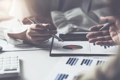 Analytics intelligence concept. Group of business people discuss current Stock Photos