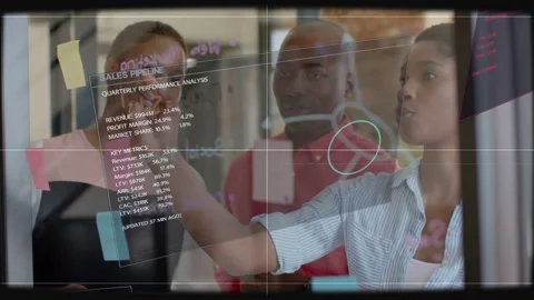 Analytics overlay appearing, three colleagues reading, circling graph and Stock Footage 333873101