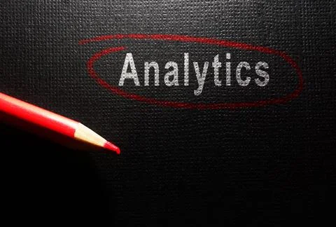 Analytics text circled in red pencil on dark textured surface Stock Photos