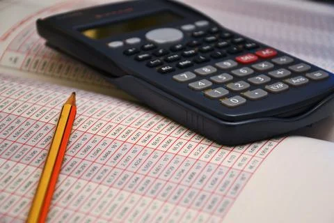 Analyze data with calculator and pencil Stock Photos