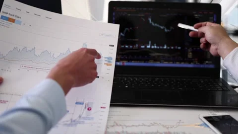 Analyze the stock trend chart with computer in the office Stock Footage 165791144