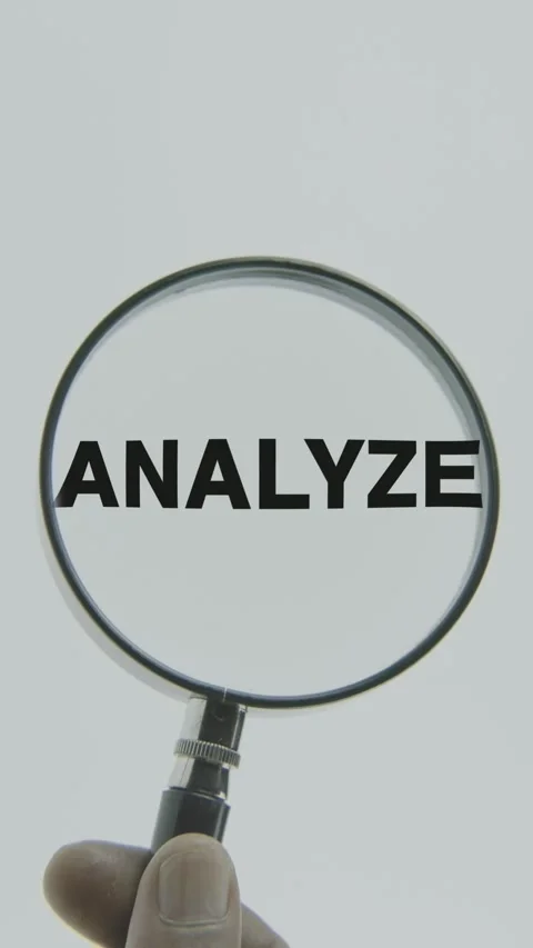Analyze text or word highlighted by a magnifying glass in a hand on a white Stock Footage 303406537