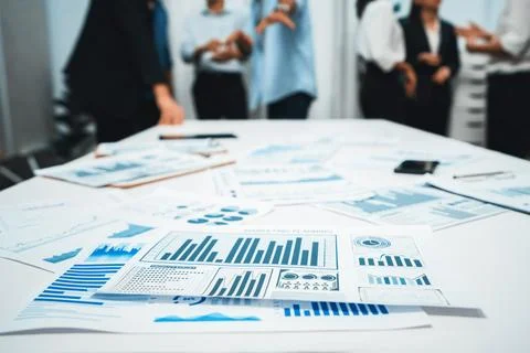 Analyzed financial data visualized papers on meeting table. Prudent Stock Photos